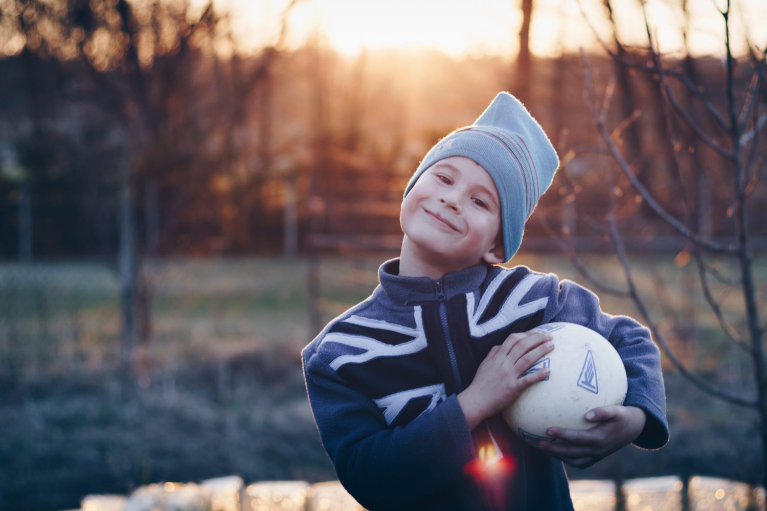 Un enfant souriant tire sa balle, avec un message d'espoir pour les survivants du cancer.