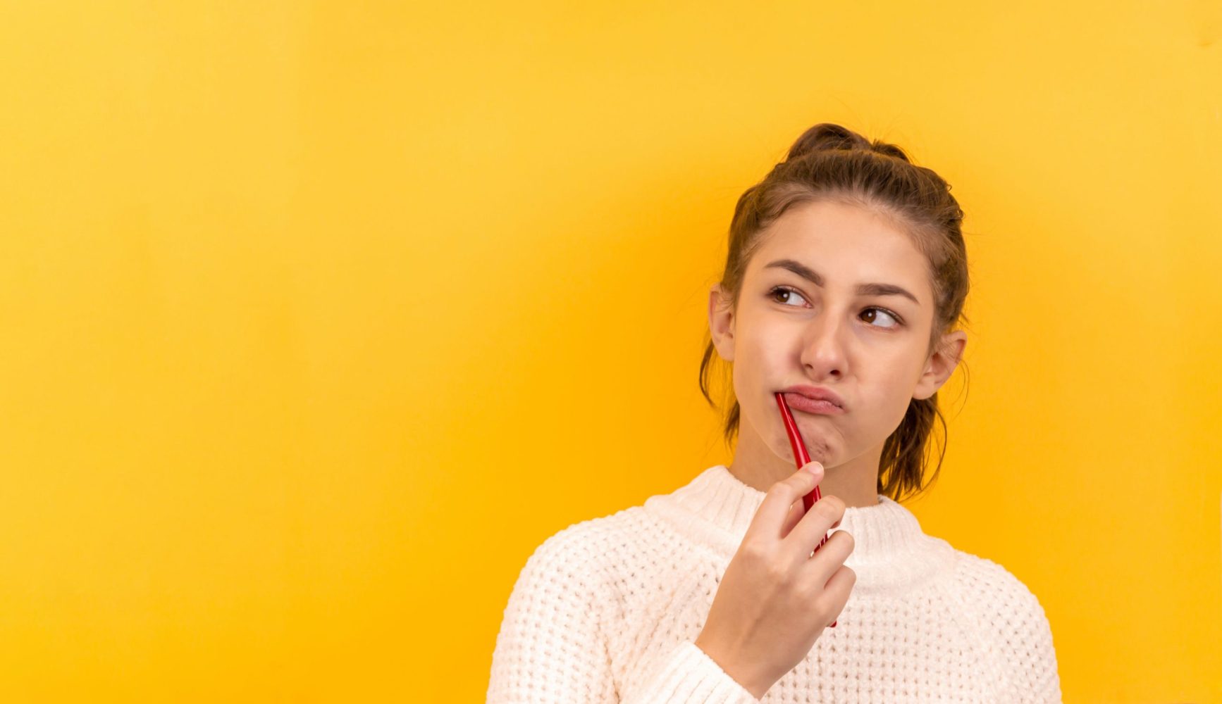 Jeune fille se brossant les dents avec une brosse à dents et du dentifrice